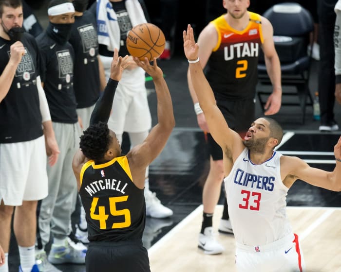 Donovan Mitchell (45) shoots a three pointer over Nicolas Batum (33)